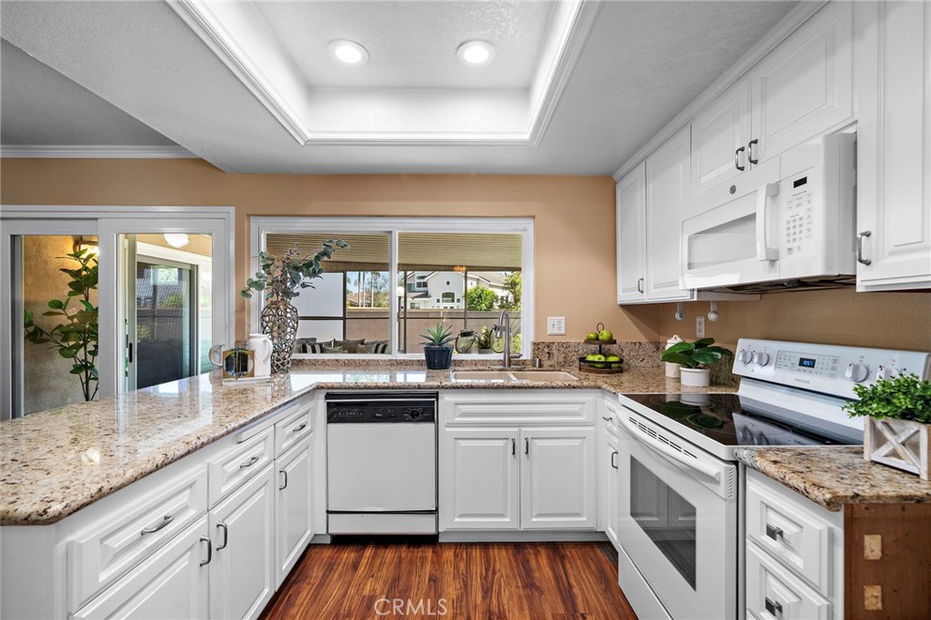 granite counter tops and large window to the indoor patio - 18898 Persimmon Circle, Fountain Valley CA 92708 - photo 10