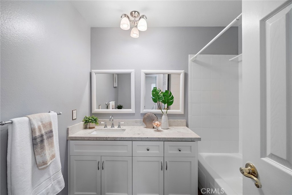 upgraded hall bathroom with shower tub combo - 18898 Persimmon Circle, Fountain Valley CA 92708 - photo 21
