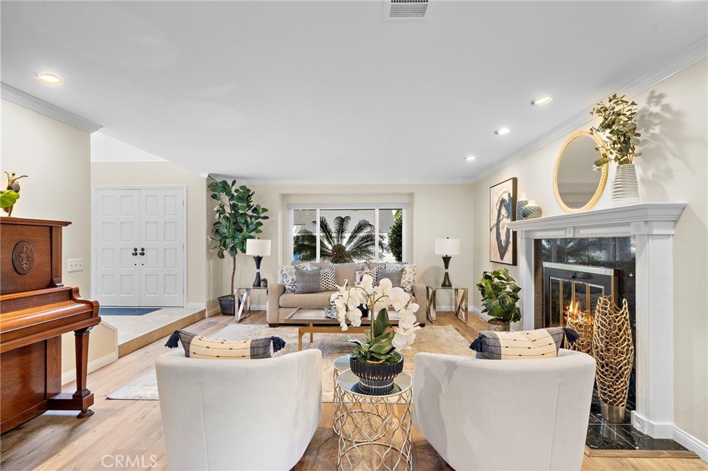 Double Door Entry, Step-Down to Formal Living Room with Engineered Wood Flooring, Bay Window, and Granite Fireplace - 8566 Phoenix Avenue, Fountain Valley CA 92708 - photo 4