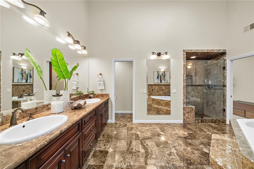spa-inspired bathroom features marble flooring, dual vanities. - 8566 Phoenix Avenue, Fountain Valley CA 92708 - photo 28