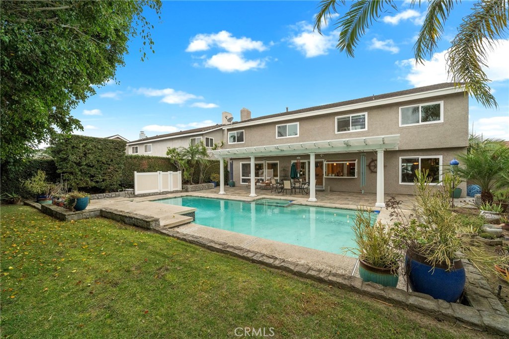 Expansive tile decking, large covered patio, lush lawn, and beautiful raised stone planters - 8566 Phoenix Avenue, Fountain Valley CA 92708 - photo 45