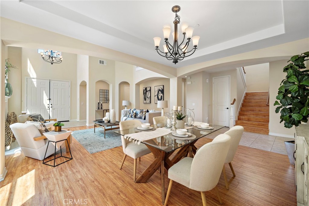 Formal dinning area view with access stairs on the right and front entry on the left. - 9042 Lemongrass Court, Fountain Valley CA 92708 - photo 12