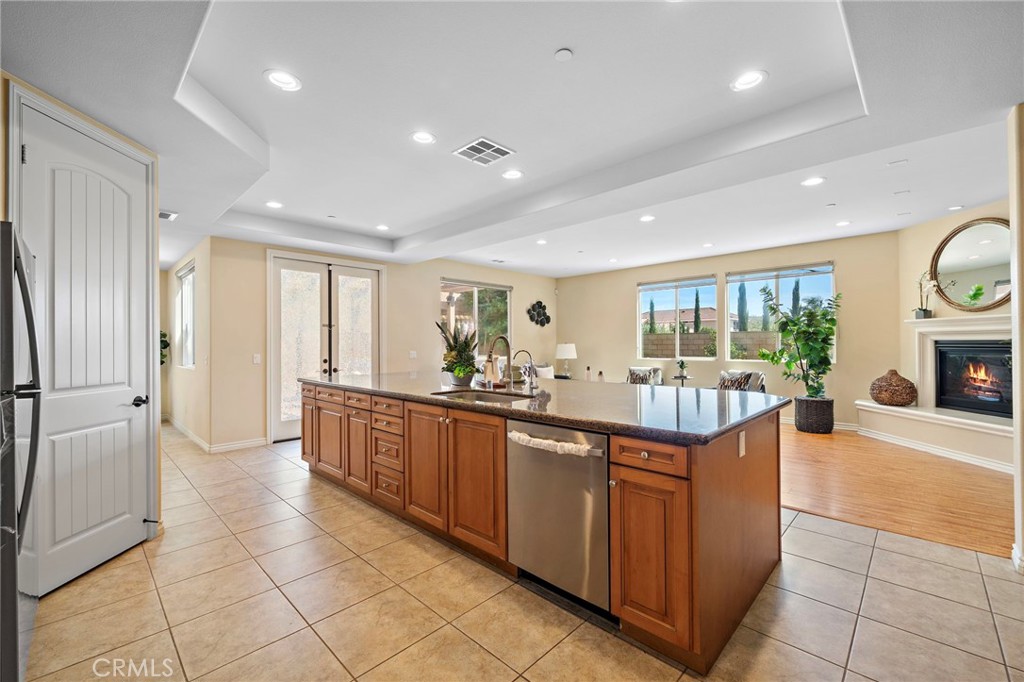 Kitchen view 2nd angle with family room in the back - 9042 Lemongrass Court, Fountain Valley CA 92708 - photo 22
