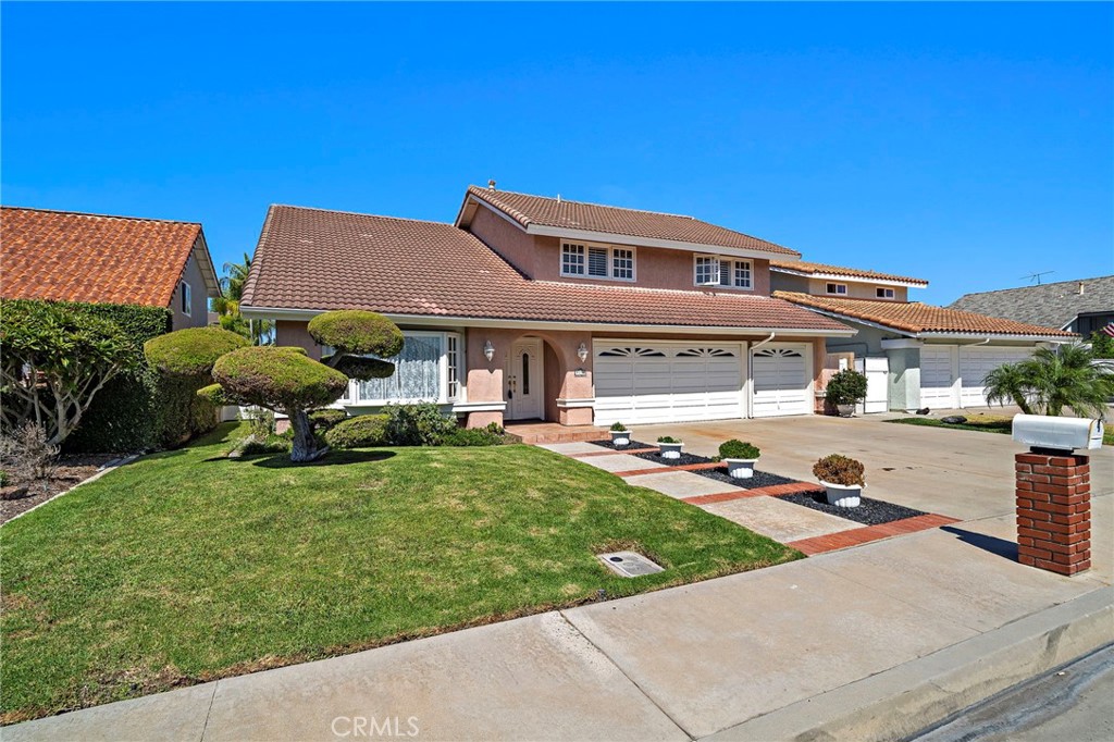 Front view of this Award Estates home and landscaped lawn - 9115 McBride River Avenue, Fountain Valley CA 92708 - photo 3