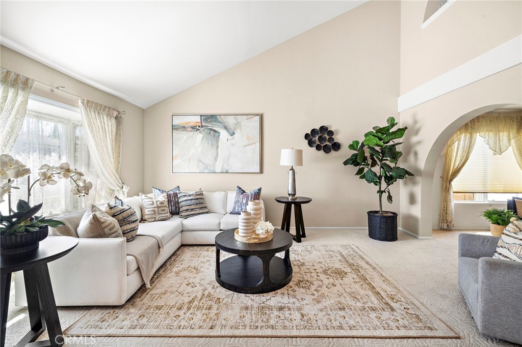 Bright living room with vaulted ceiling, bay window, and abundant natural light - 9115 McBride River Avenue, Fountain Valley CA 92708 - photo 4