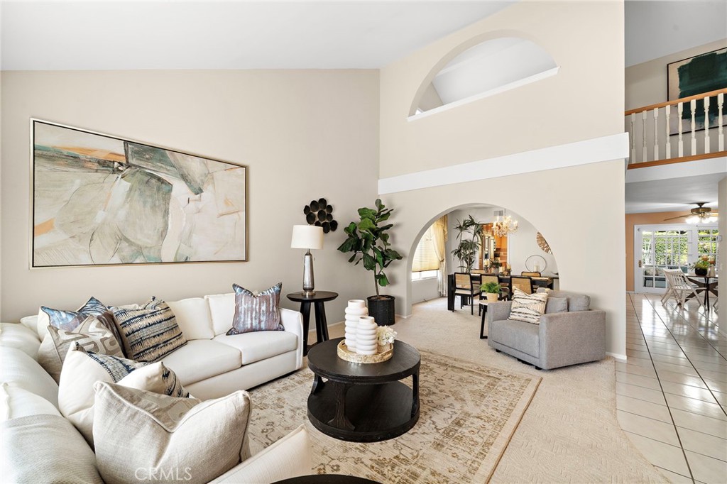 Living room with an arched opening to the dining area - 9115 McBride River Avenue, Fountain Valley CA 92708 - photo 7