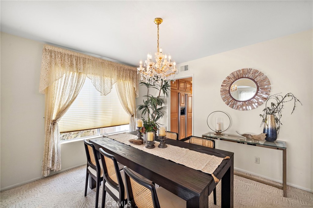Arched passages set off the elegant formal dining room with chandelier - 9115 McBride River Avenue, Fountain Valley CA 92708 - photo 8