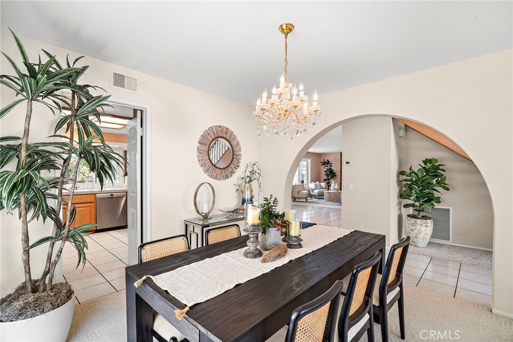 Dining room framed by graceful arched openings - 9115 McBride River Avenue, Fountain Valley CA 92708 - photo 9