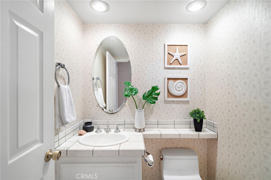 Guest bathroom with pedestal sink - 9115 McBride River Avenue, Fountain Valley CA 92708 - photo 23