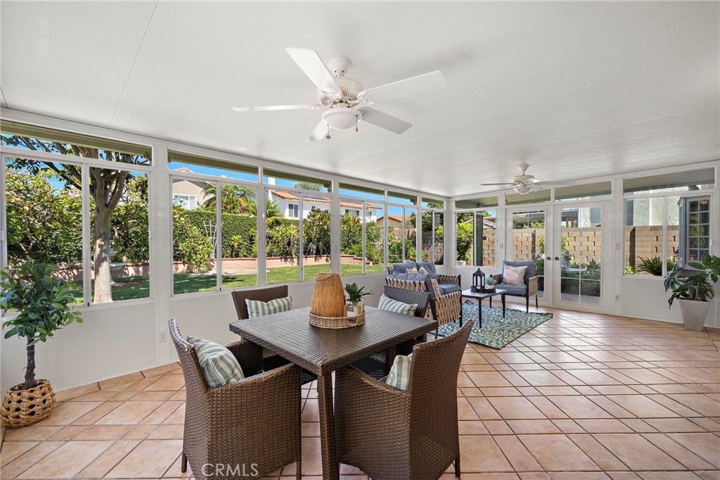 Sunroom surrounded by windows overlooking the backyard - 9115 McBride River Avenue, Fountain Valley CA 92708 - photo 28