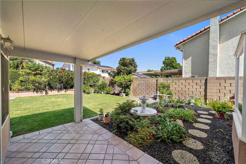 Covered patio overlooking the landscaped backyard - 9115 McBride River Avenue, Fountain Valley CA 92708 - photo 41