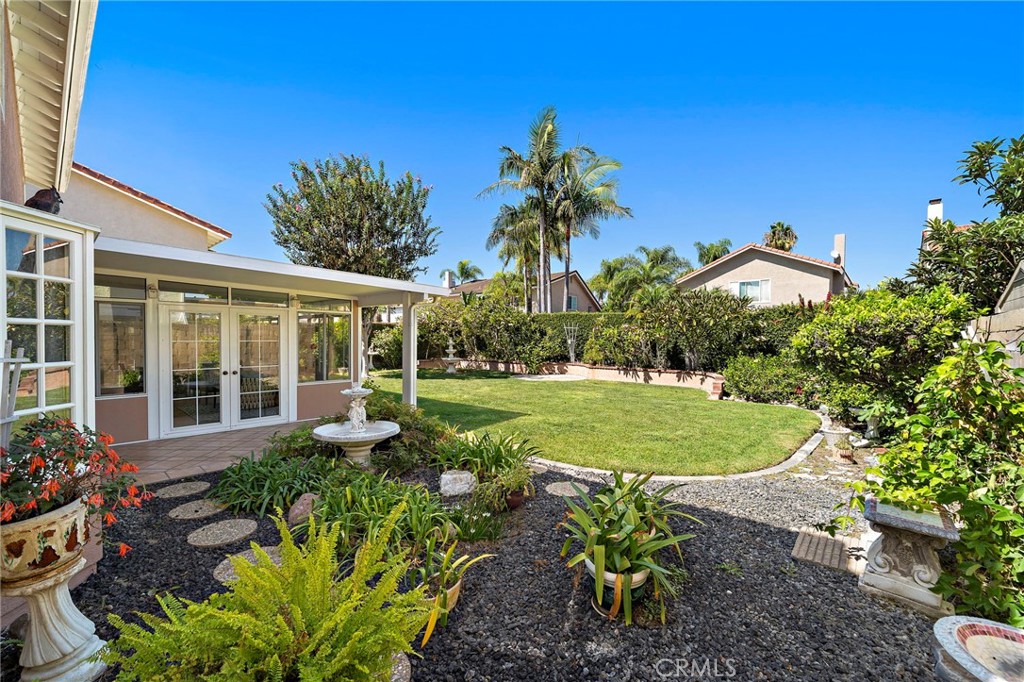 Lush backyard with lawn, mature plantings, and patio - 9115 McBride River Avenue, Fountain Valley CA 92708 - photo 42
