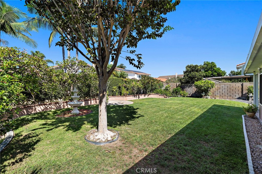 Fountains, Shade Trees, Tropical Foliage, Raise Planters, Block Wall Privacy Fencing all Make this Backyard the Perfect - 9115 McBride River Avenue, Fountain Valley CA 92708 - photo 47