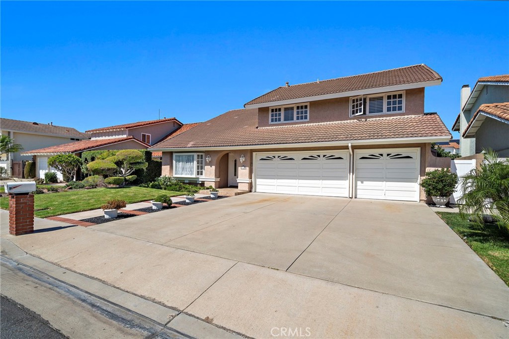 Broad driveway and attached 3 car garage complement the home’s attractive exterior. - 9115 McBride River Avenue, Fountain Valley CA 92708 - photo 3