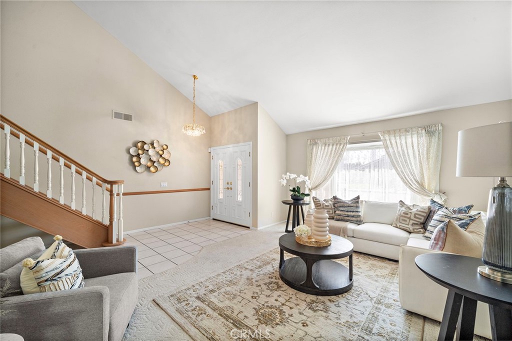 Welcoming living room with an open view toward the staircase. - 9115 McBride River Avenue, Fountain Valley CA 92708 - photo 6