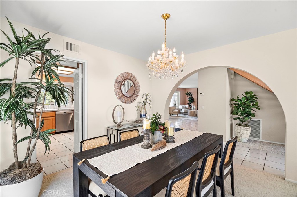 Inviting dining space with a graceful arched opening. - 9115 McBride River Avenue, Fountain Valley CA 92708 - photo 9
