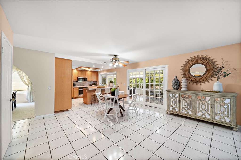 Spacious casual dining area with tiled flooring and an open layout. - 9115 McBride River Avenue, Fountain Valley CA 92708 - photo 12