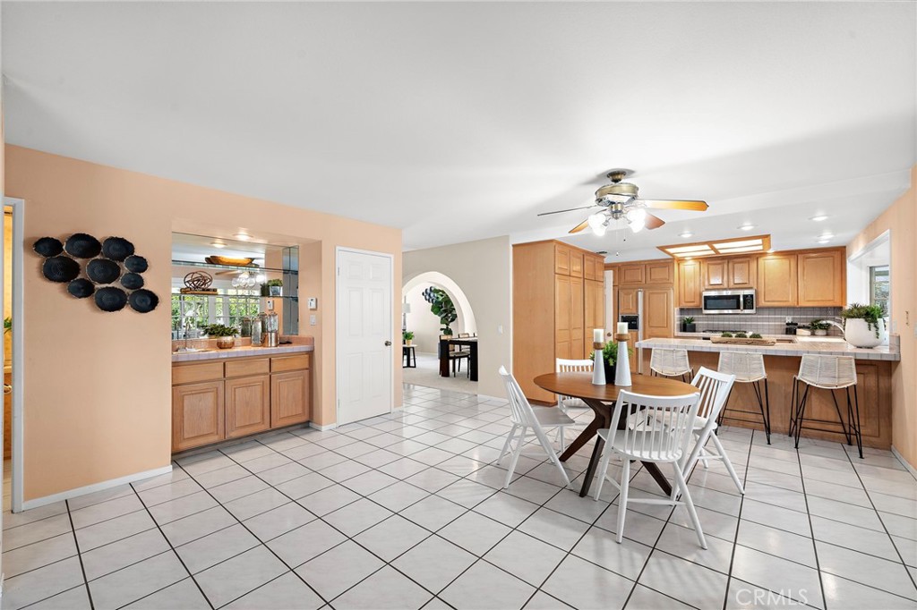 Open kitchen and breakfast area with generous cabinet storage. - 9115 McBride River Avenue, Fountain Valley CA 92708 - photo 13