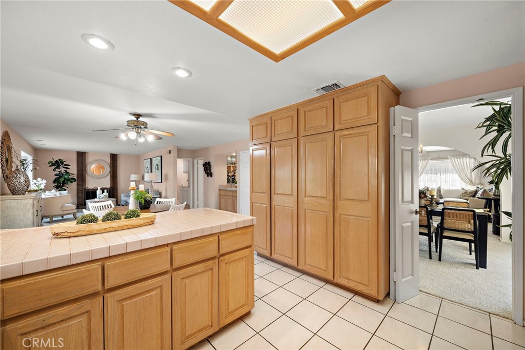 Well-planned kitchen with generous pantry-style cabinetry and counter space. - 9115 McBride River Avenue, Fountain Valley CA 92708 - photo 21