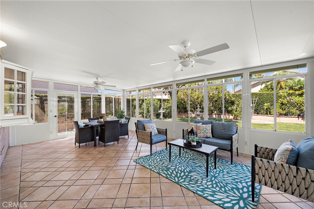 Window-lined sunroom offers space for dining and relaxing. - 9115 McBride River Avenue, Fountain Valley CA 92708 - photo 25