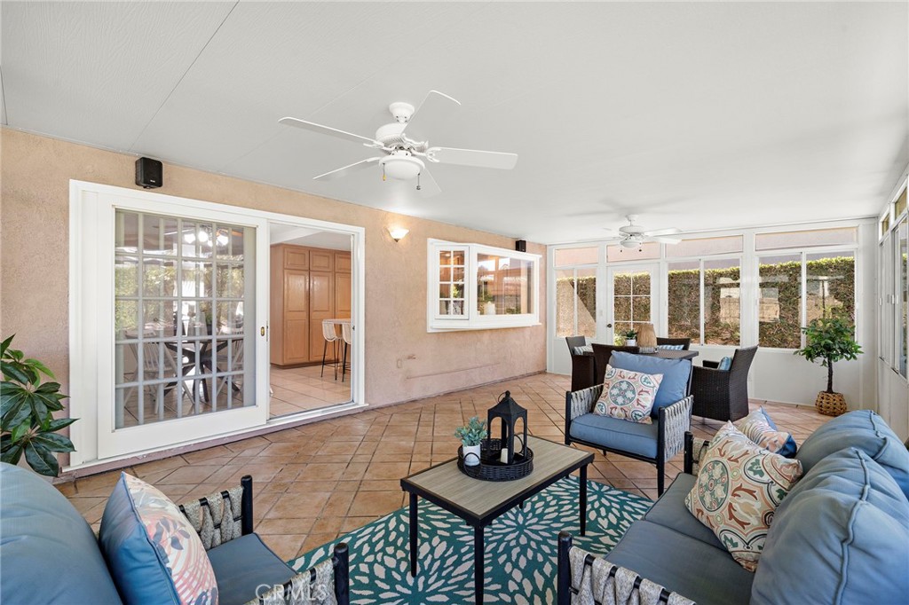 Spacious sunroom with backyard views and multiple seating areas. - 9115 McBride River Avenue, Fountain Valley CA 92708 - photo 26