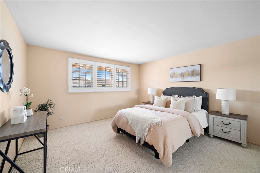 Comfortable bedroom with a wide window and soft natural light. - 9115 McBride River Avenue, Fountain Valley CA 92708 - photo 31