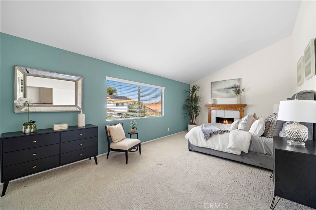 Generous bedroom with a colorful accent wall and ample furnishing space. - 9115 McBride River Avenue, Fountain Valley CA 92708 - photo 36