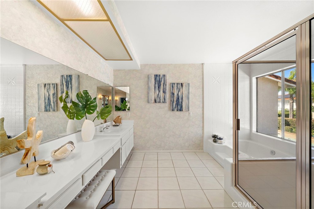 Expansive vanity counter and mirrored wall provide a bright getting-ready space. - 9115 McBride River Avenue, Fountain Valley CA 92708 - photo 39