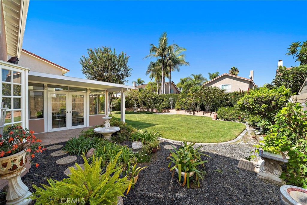 Landscaped backyard with lawn, garden beds and room to enjoy the sunshine. - 9115 McBride River Avenue, Fountain Valley CA 92708 - photo 42