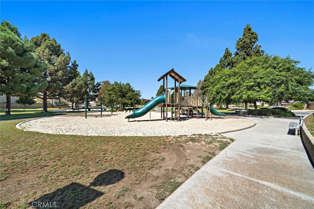 Helm Park playground with open space and a paved walking path. - 9115 McBride River Avenue, Fountain Valley CA 92708 - photo 49