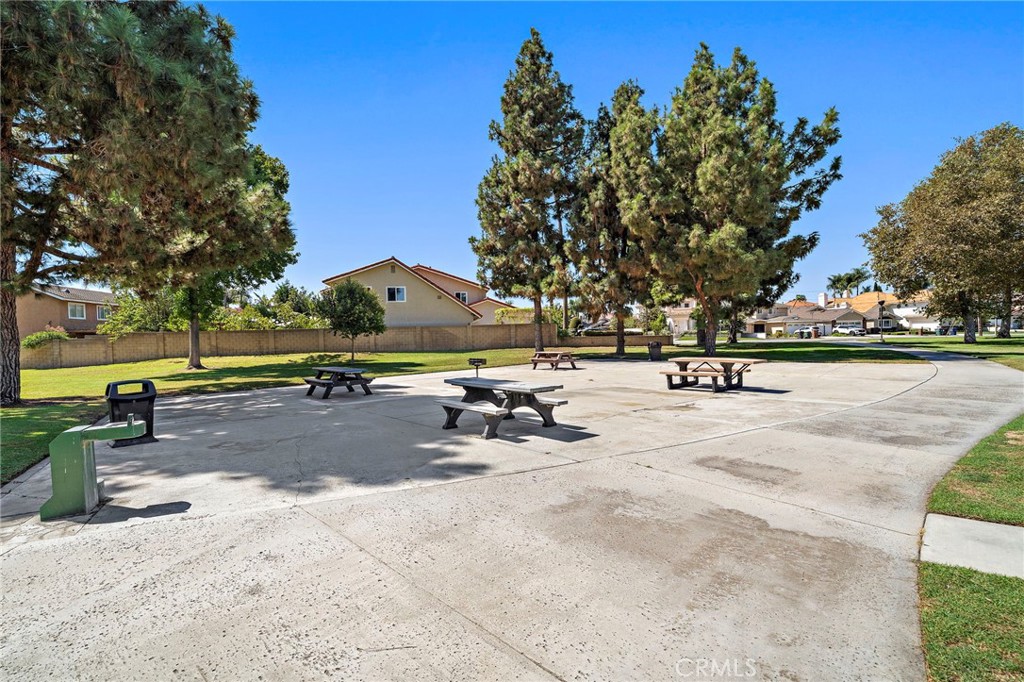Park picnic area with tables beneath mature shade trees. - 9115 McBride River Avenue, Fountain Valley CA 92708 - photo 52