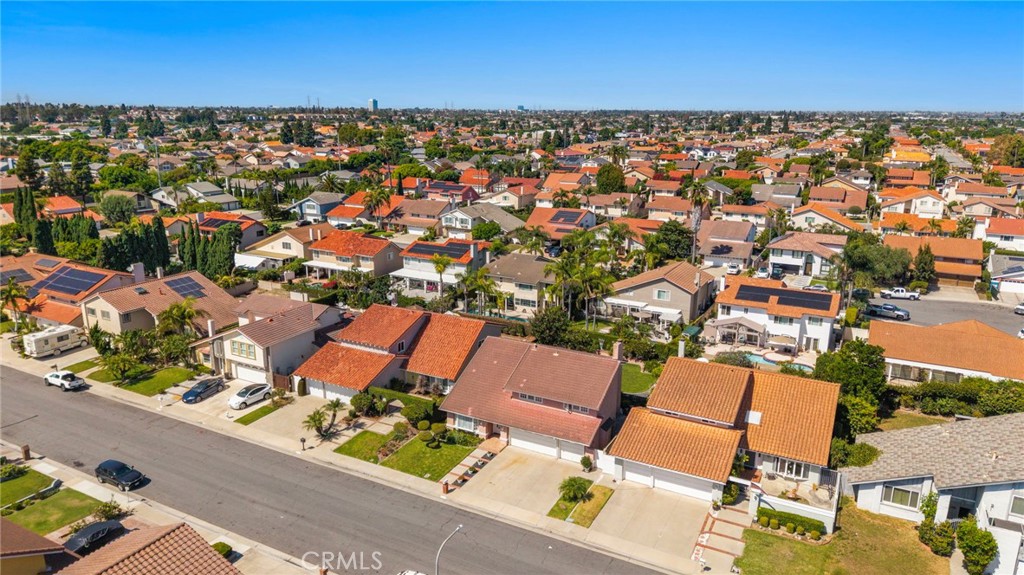 Wide aerial view places the home within its surrounding neighborhood. - 9115 McBride River Avenue, Fountain Valley CA 92708 - photo 59