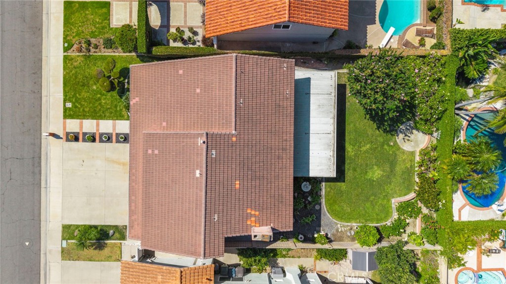 Overhead view shows the home’s footprint and landscaped outdoor areas. - 9115 McBride River Avenue, Fountain Valley CA 92708 - photo 63
