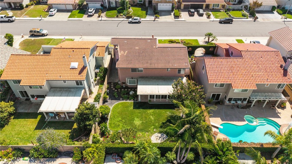 Rear aerial perspective highlights the home and garden layout. - 9115 McBride River Avenue, Fountain Valley CA 92708 - photo 65