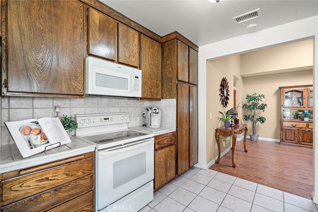 kitchen leads to large dining room - 9735 Hibiscus Avenue, Fountain Valley CA 92708 - photo 13