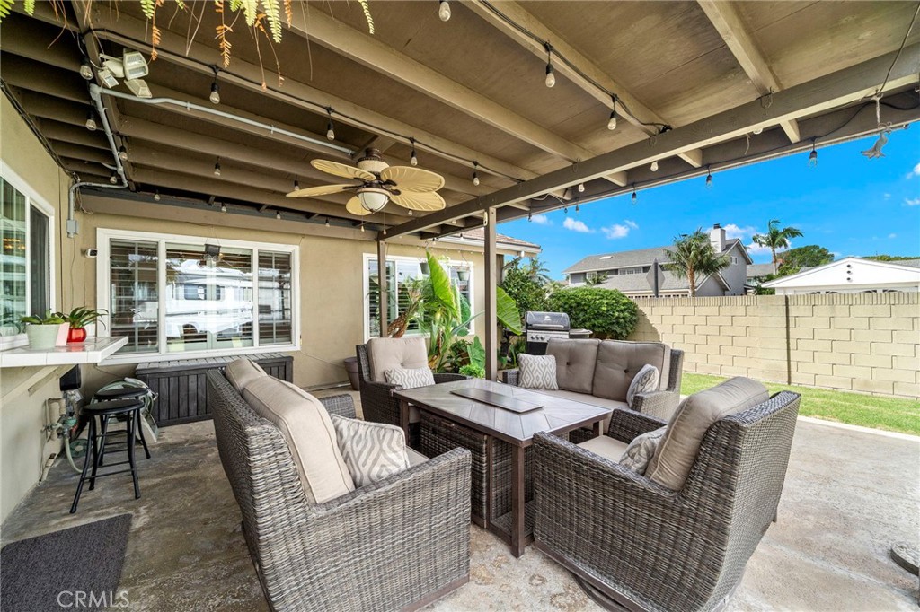 wood covered patio with fan - 9735 Hibiscus Avenue, Fountain Valley CA 92708 - photo 28