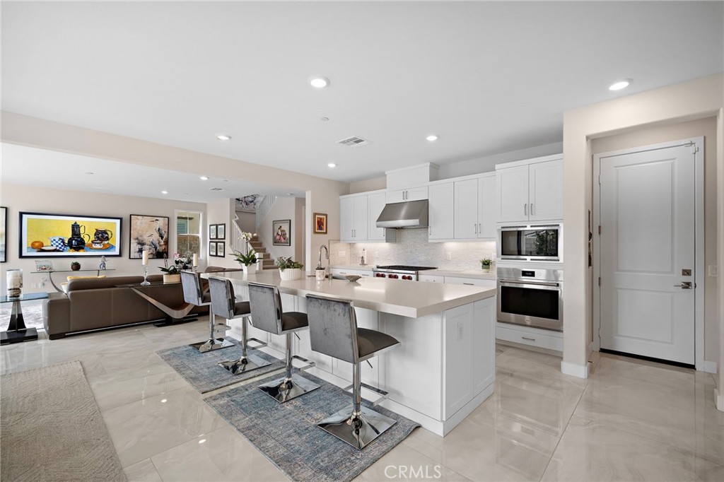 The spectacular gourmet kitchen is truly the heart of the home, featuring an oversized center island with generous seati - 9896 Heron Avenue, Fountain Valley CA 92708 - photo 9