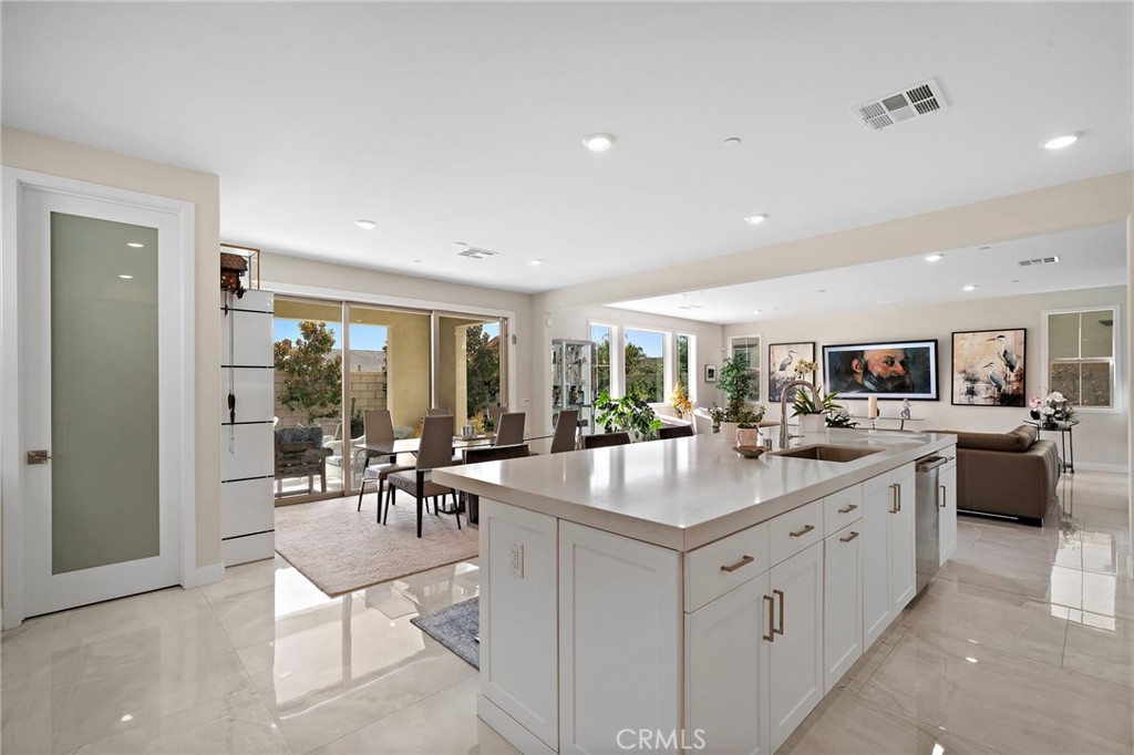 Chef's Dream kitchen featuring an oversized center island with generous seating, quartz countertops, Wolf stainless stee - 9896 Heron Avenue, Fountain Valley CA 92708 - photo 10