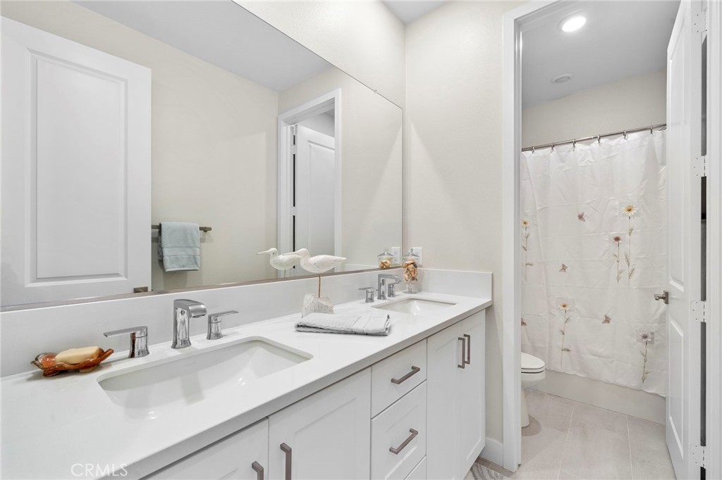 Upstairs Guest Bathroom with Dual Sinks and Tub/Shower Combo - 9896 Heron Avenue, Fountain Valley CA 92708 - photo 28