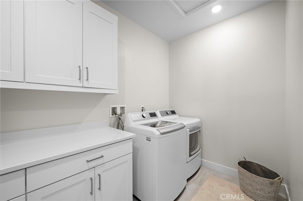 Upstairs laundry room w/ ample cabinets & storage - 9896 Heron Avenue, Fountain Valley CA 92708 - photo 33