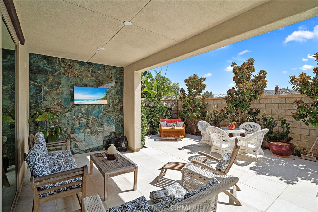 Inviting outdoor California patio with beautiful accent wall & TV - 9896 Heron Avenue, Fountain Valley CA 92708 - photo 34