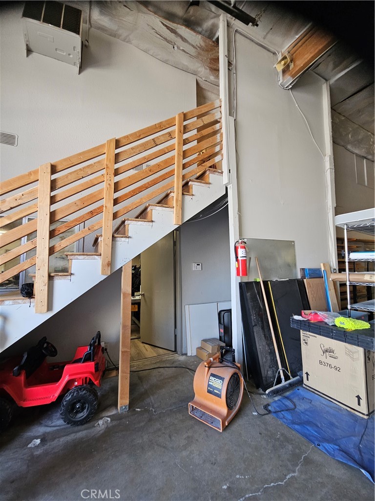 Stairs to mezzanine storage rooms. - 1124 E Valencia, Fullerton CA 92831 - photo 11