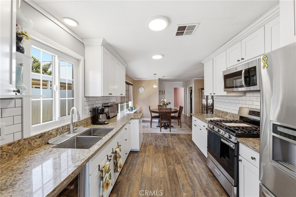 The spacious kitchen offers ample room for cooking, meal preparation, and entertaining family and friends. - 1201 W Valencia Drive 13, Fullerton CA 92833 - photo 3
