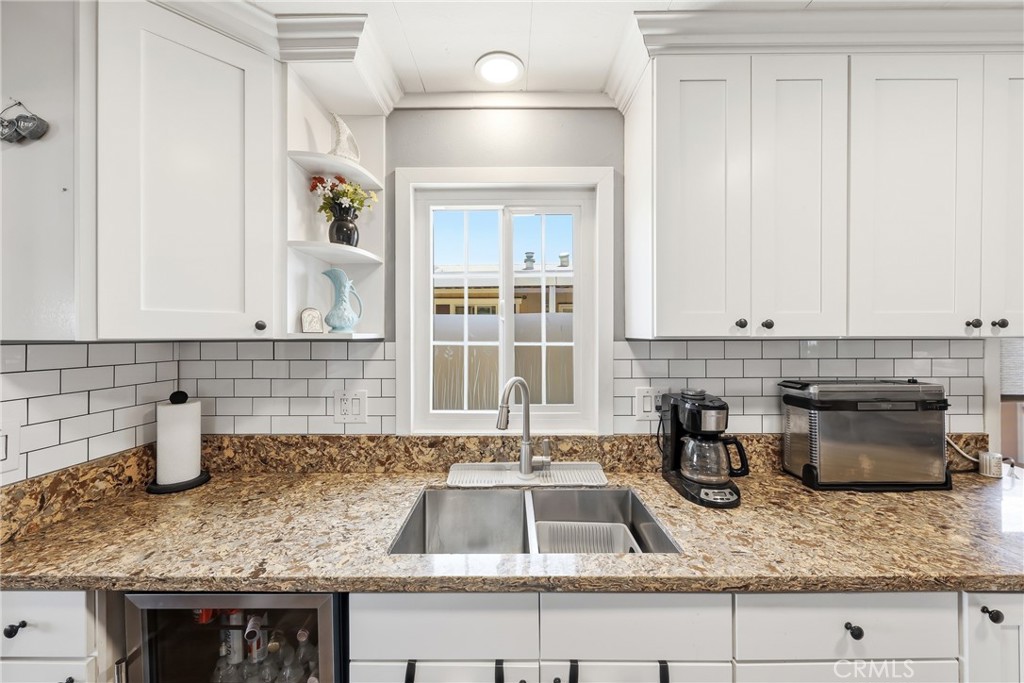 The kitchen has been tastefully upgraded with granite countertops, shaker-style soft-close cabinets and drawers, an upda - 1201 W Valencia Drive 13, Fullerton CA 92833 - photo 13