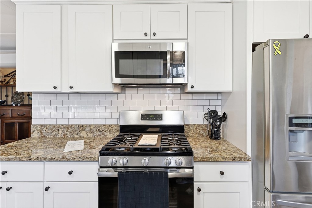 This well-designed kitchen offers an abundance of cabinet and drawer space, providing ample storage to keep everything o - 1201 W Valencia Drive 13, Fullerton CA 92833 - photo 15