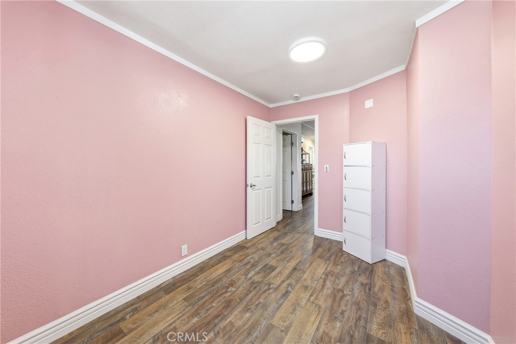 Comfortable and inviting guest bedroom featuring ample space, natural light, and a versatile layout to accommodate famil - 1201 W Valencia Drive 13, Fullerton CA 92833 - photo 20