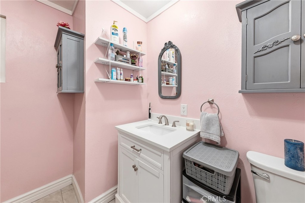 The primary bathroom has been recently upgraded with a refreshed vanity, new cabinetry, updated paint, and a new toilet, - 1201 W Valencia Drive 13, Fullerton CA 92833 - photo 23