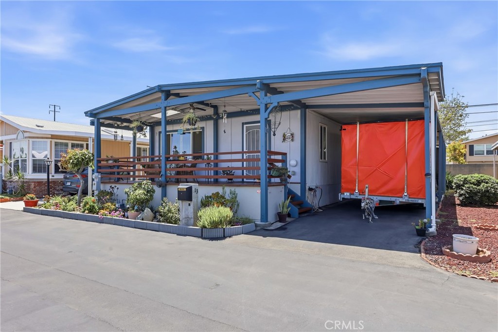 The carport features a tandem layout that comfortably accommodates two vehicles parked in line with each other. - 1201 W Valencia Drive 13, Fullerton CA 92833 - photo 28
