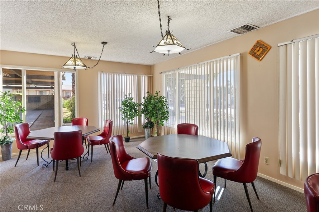 Bright clubhouse dining area with plenty of seating and lighting. - 1201 W Valencia Drive 13, Fullerton CA 92833 - photo 33