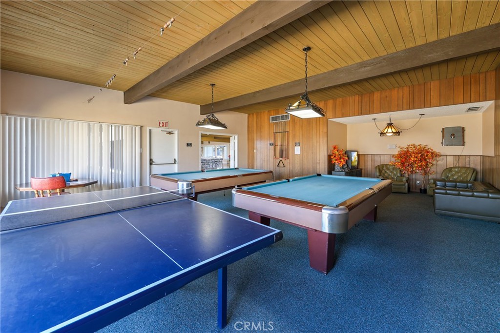 The clubhouse billiard room features pool tables, table tennis, ample seating, and abundant lighting, creating a fun and - 1201 W Valencia Drive 13, Fullerton CA 92833 - photo 36